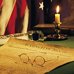 Declaration of Independence with American flag in the background