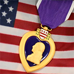 Image of the Purple Heart Medal on the American flag: Source Department of Defense